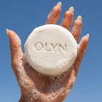 Woman holding OLYN soap for women