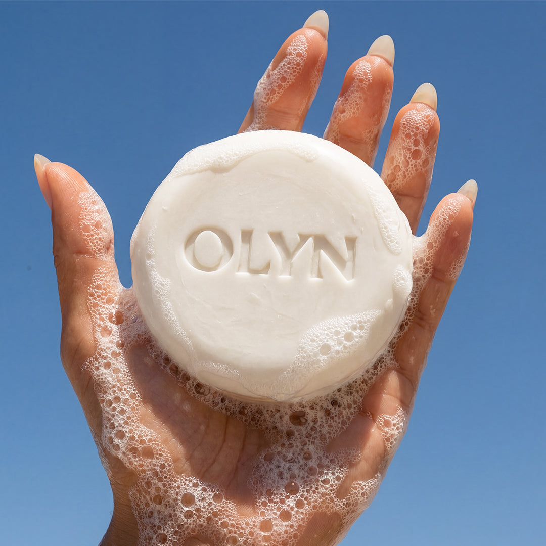 Woman holding OLYN soap for women